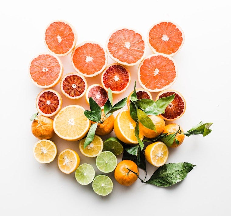 citrusvruchten op een witte achtergrond, waaronder grapefruit, sinaasappel, citroen, limoen - geuren die katten haten